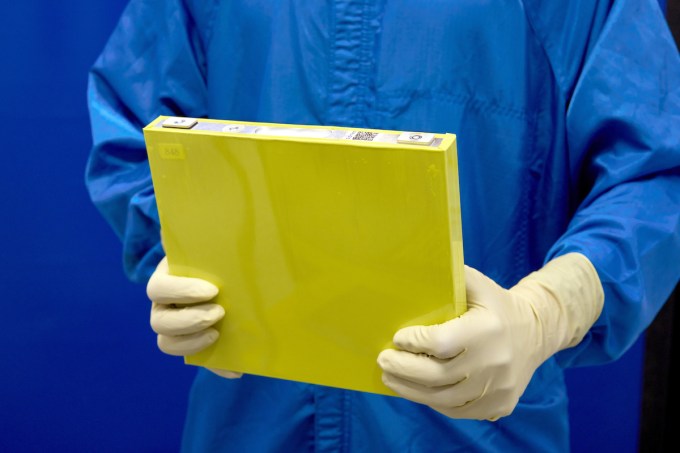A technician holds a prototype battery.